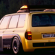A yellow Renault Espace minivan fitted with an F1 engine